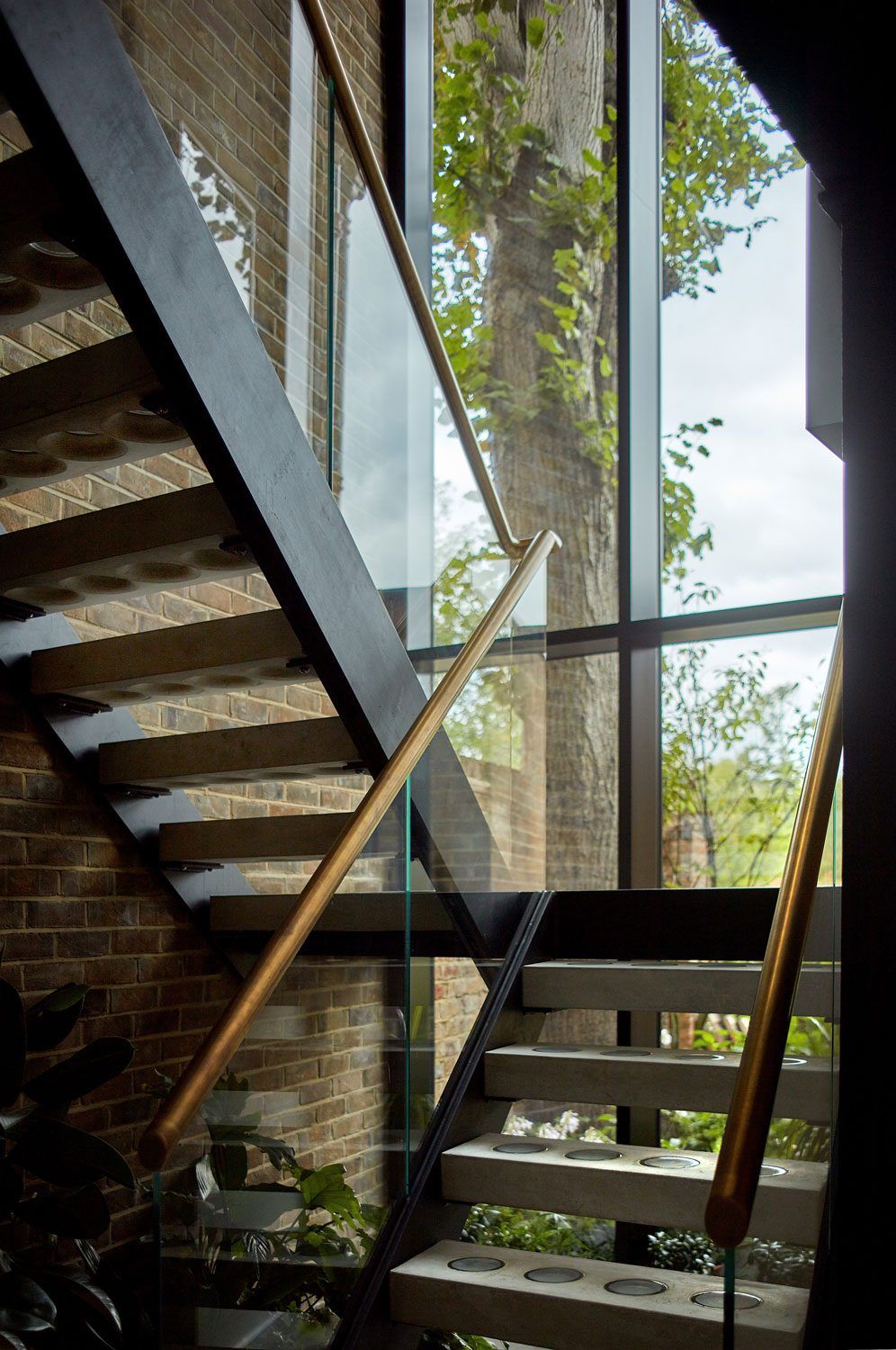 Steel and timber staircase with full-height glazing in a Hampstead house extension