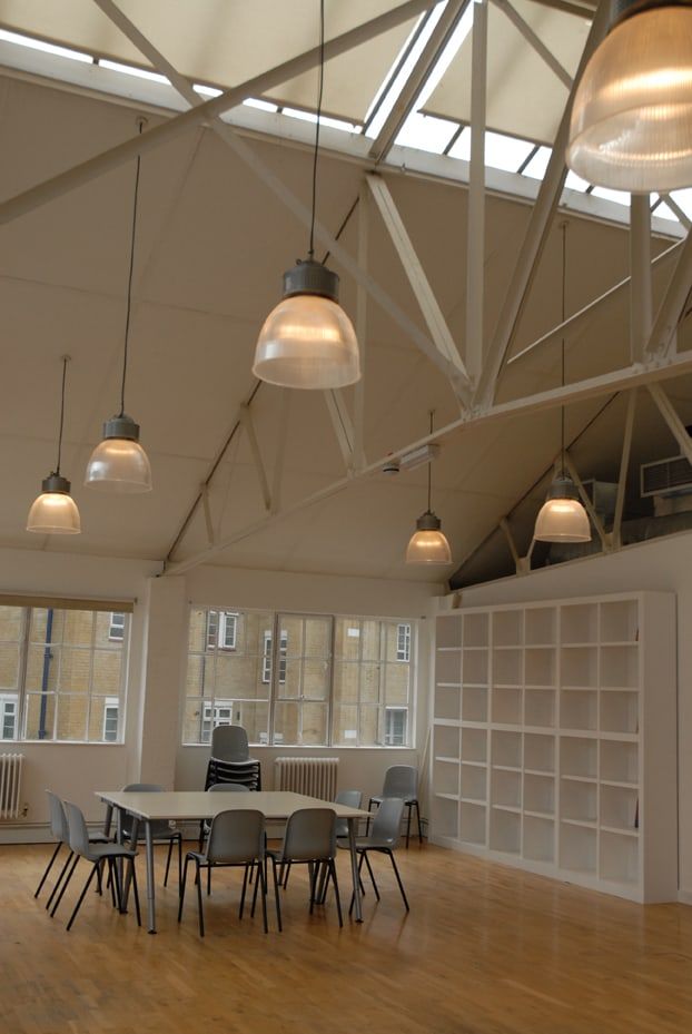 Studio space with pendant lighting and a timber grid wall
