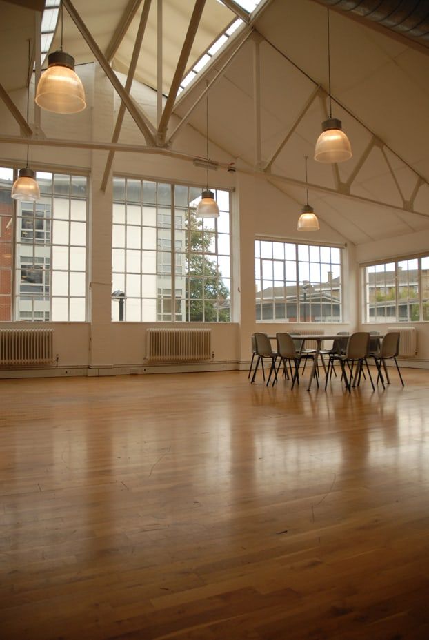 Open studio floor with timber flooring and steel-framed windows