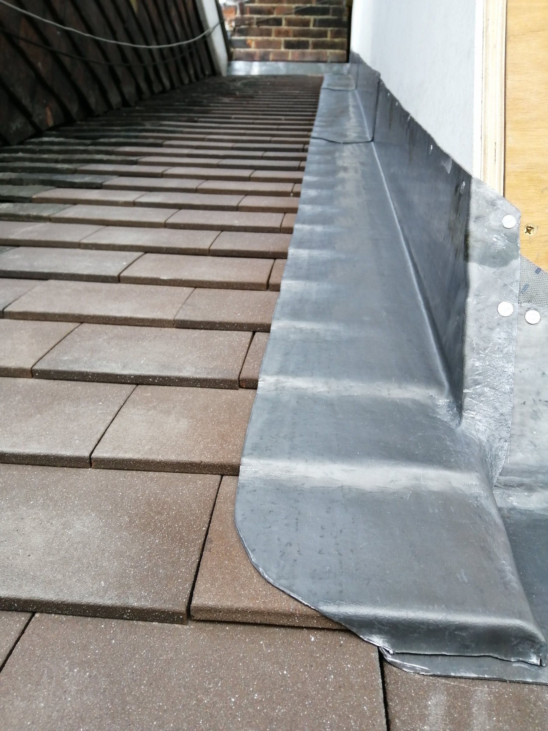 Lead flashing detail where the dormer meets the tiled roof